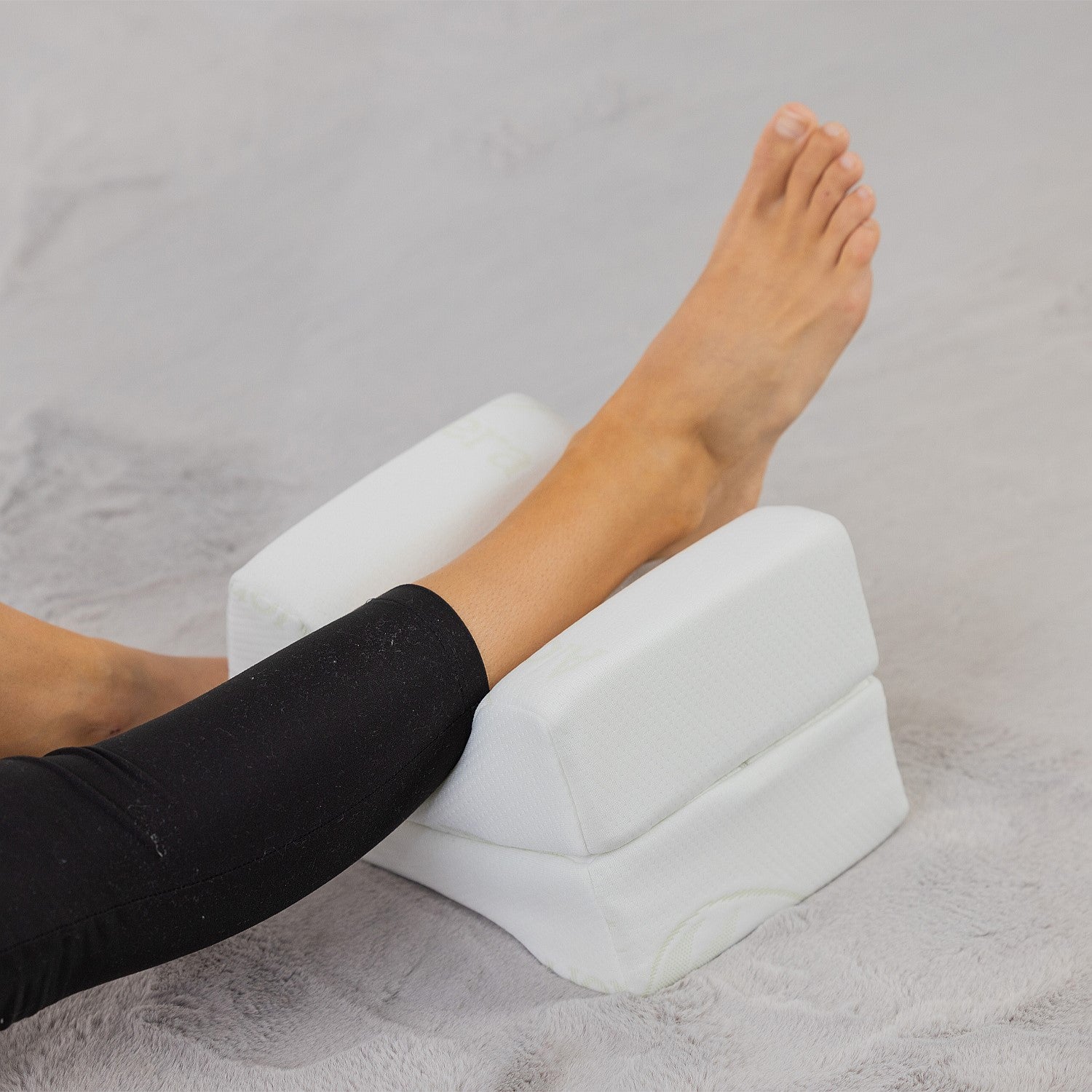 Aloe Vera memory foam leg pillow supporting the lower leg and ankle while resting.