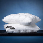Two white pinch-pleat pillows stacked together, showcasing the plush loft, decorative texture, and piped edge finish of the Dr Hotel  Pillow.

