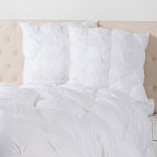 European pillows with elegant pinch-pleat detailing displayed on a bed, adding texture, comfort, and a sophisticated finishing touch to the bedroom.