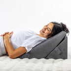 Solace Multi-Purpose Wedge Support Pillow used in a reclined position to support the upper body and head.