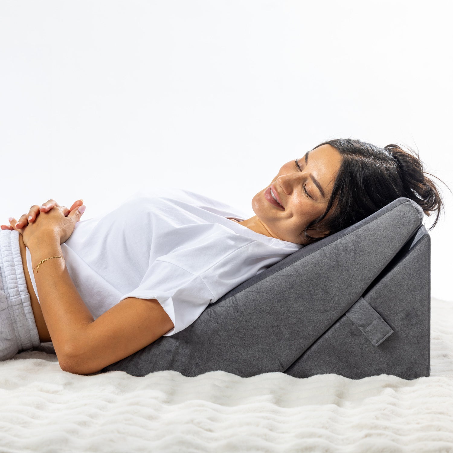 Solace Multi-Purpose Wedge Support Pillow used in a reclined position to support the upper body and head.