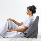 Solace Multi-Purpose Wedge Support Pillow positioned upright behind the back for seated support.