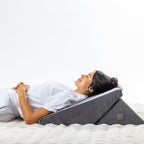 Solace Multi-Purpose Wedge Support Pillow arranged at a lower incline for relaxed upper-body support while lying down.