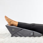Solace Multi-Purpose Wedge Support Pillow positioned under the lower legs and feet for elevation.
