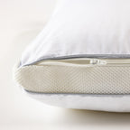 Close-up of an adjustable pillow with a zippered opening and removable foam core insert for customised height and support.