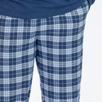 Man wearing blue check flannelette pyjama pants.