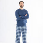 Man wearing a blue long sleeve top with blue check flannelette pyjama pants.