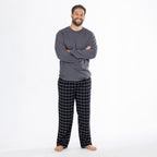 Man wearing a dark grey long sleeve top with black check flannelette pyjama pants.