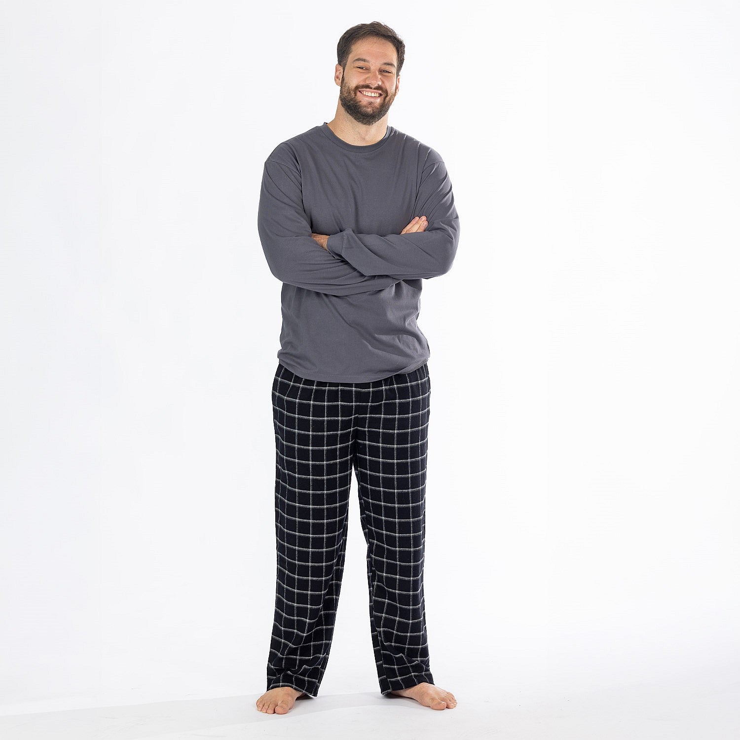 Man wearing a dark grey long sleeve top with black check flannelette pyjama pants.