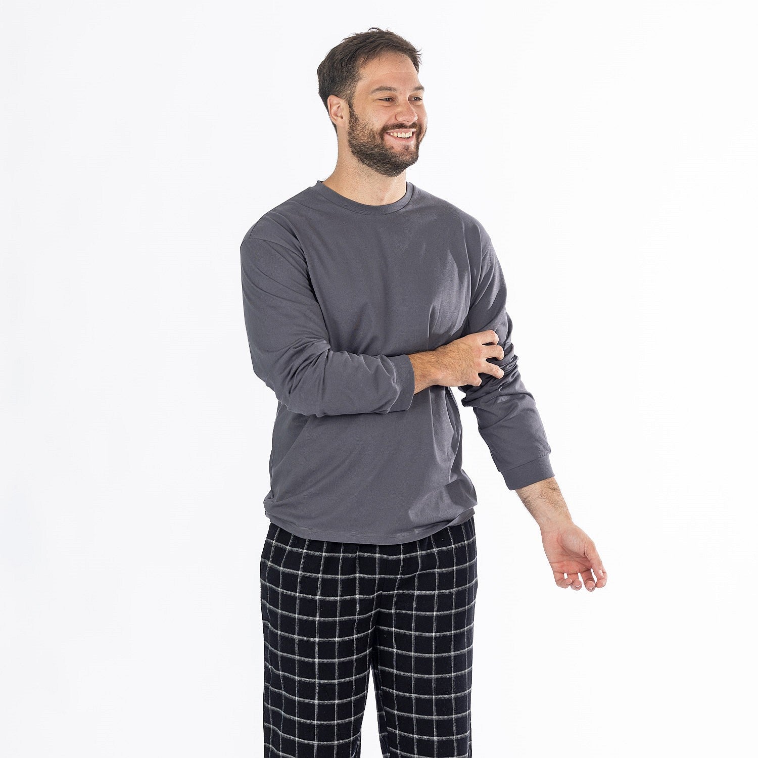 Man wearing a dark grey long sleeve top with black check flannelette pyjama pants.