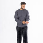 Man wearing a dark grey long sleeve top with black check flannelette pyjama pants.