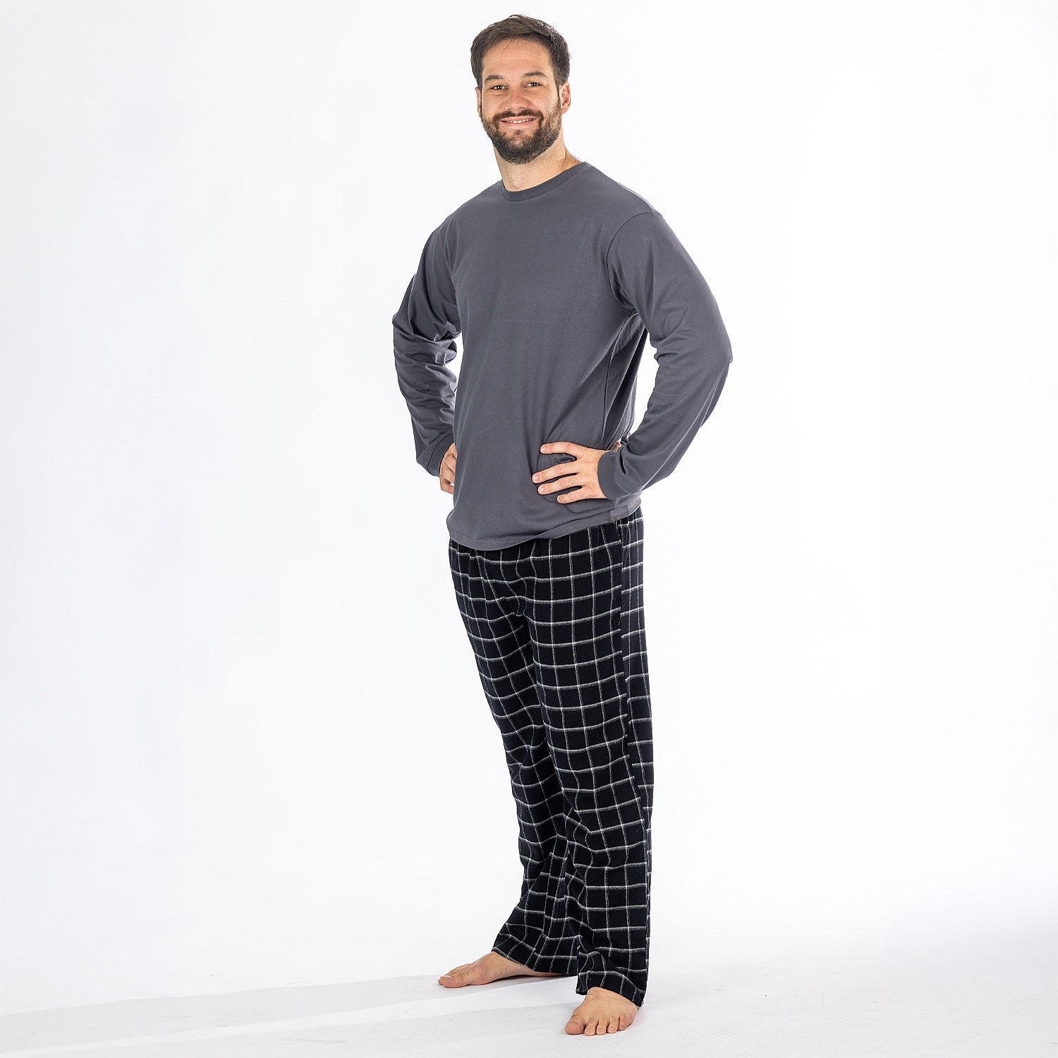 Man wearing a dark grey long sleeve top with black check flannelette pyjama pants.