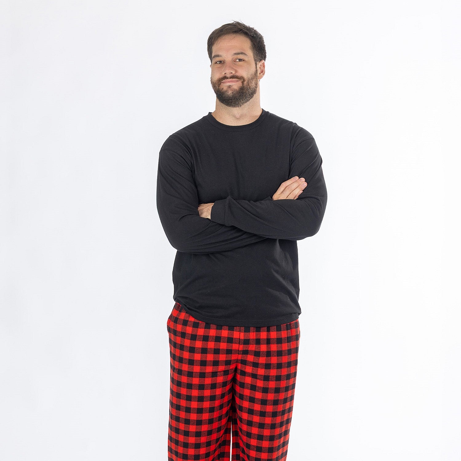 Man wearing a black long sleeve top with red and black check flannelette pyjama pants.