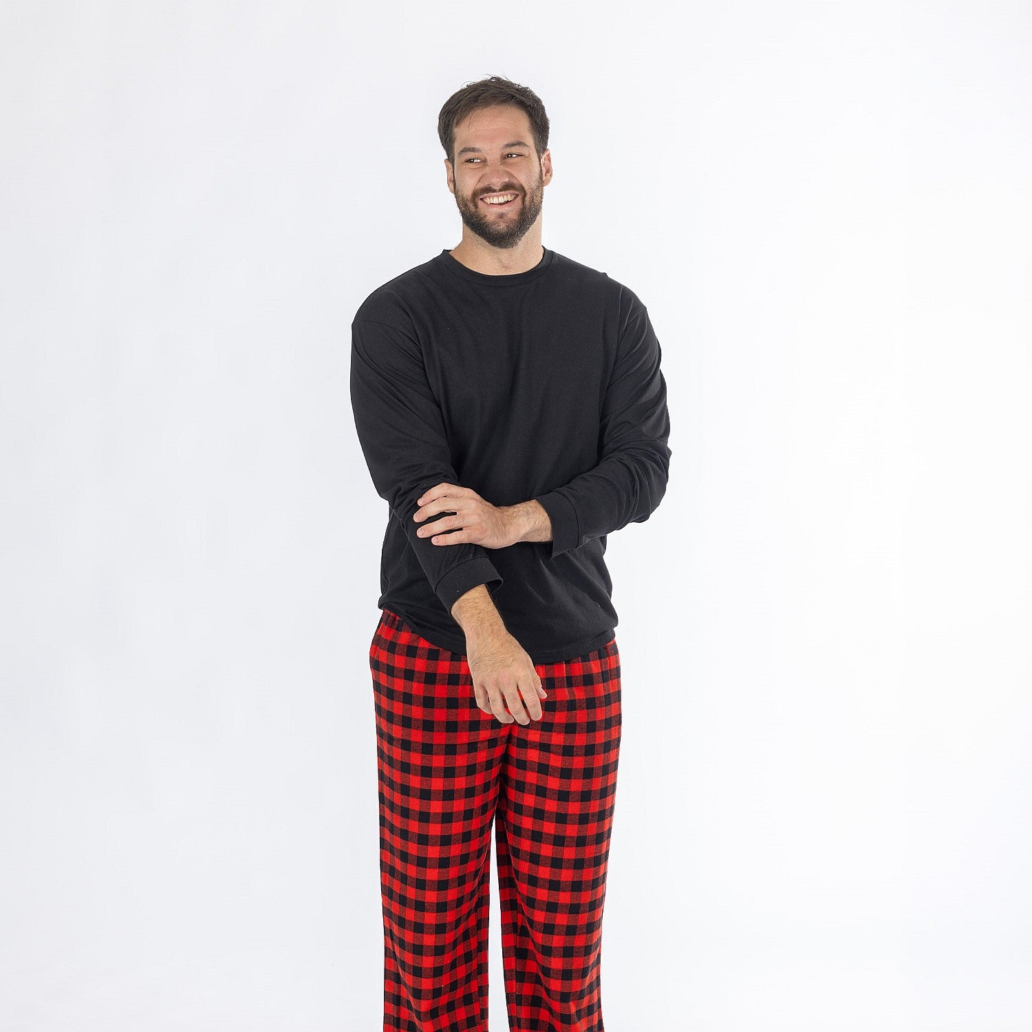 Man wearing a black long sleeve top with red and black check flannelette pyjama pants.