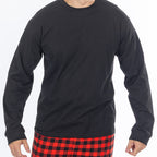 Close up of man wearing a black long sleeve top with red and black check flannelette pyjama pants.