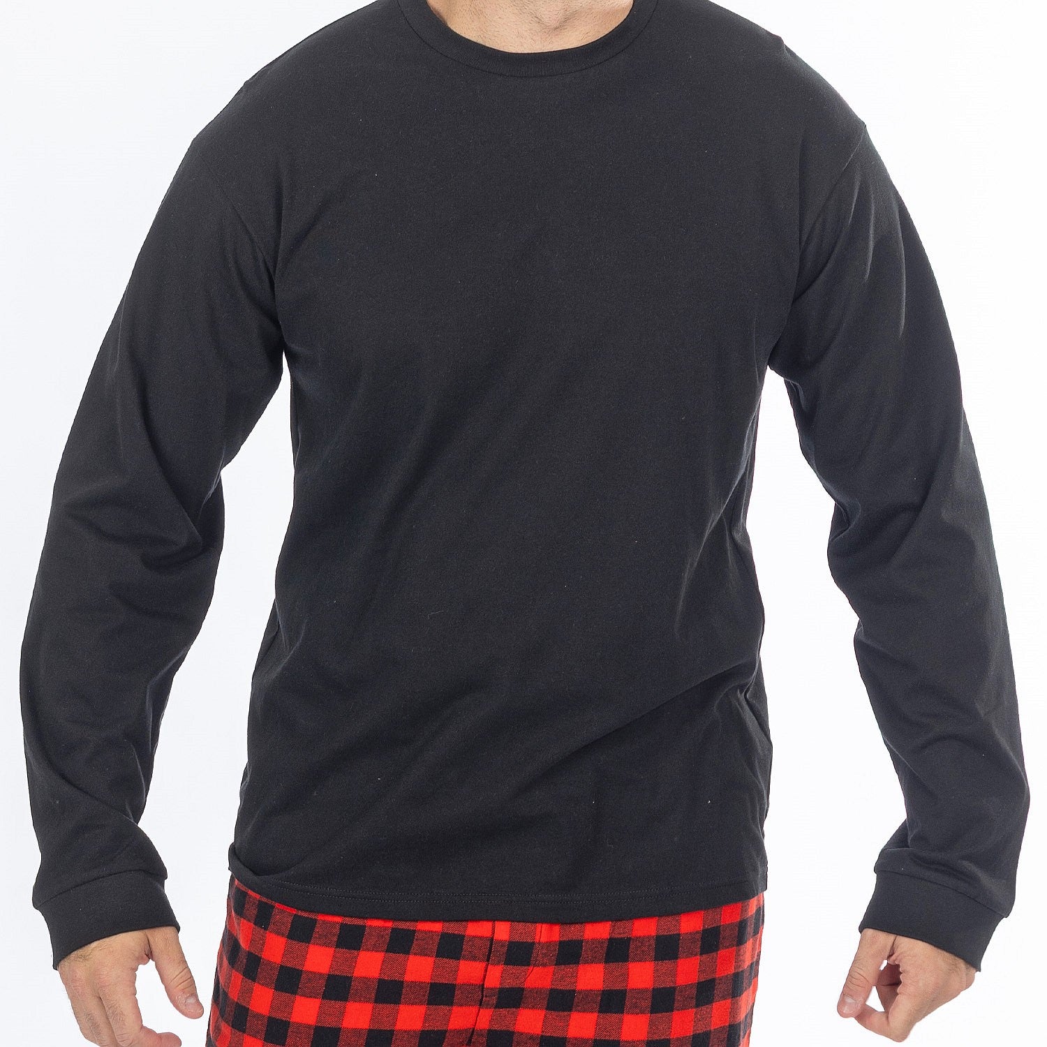 Close up of man wearing a black long sleeve top with red and black check flannelette pyjama pants.