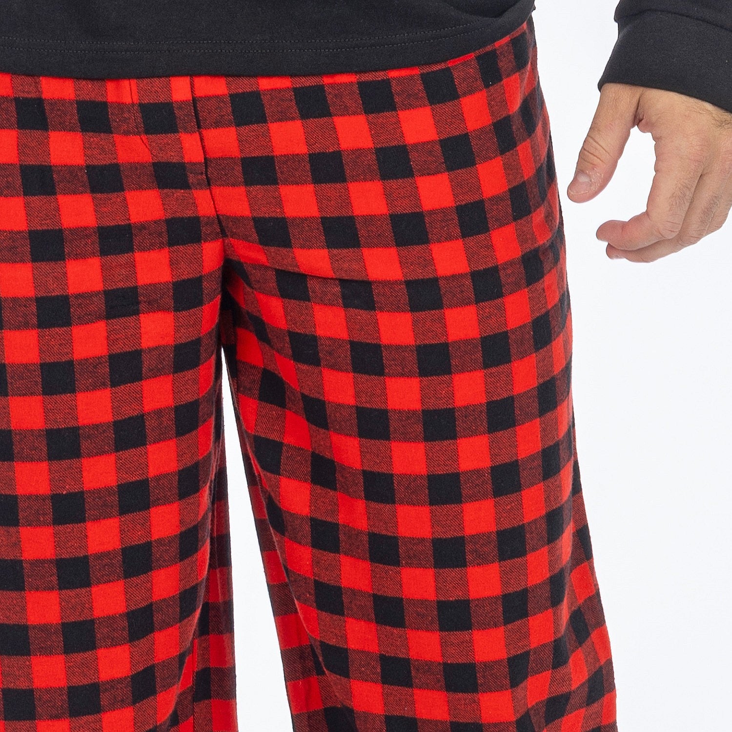 Close up of a man wearing red and black check flannelette pyjama pants.