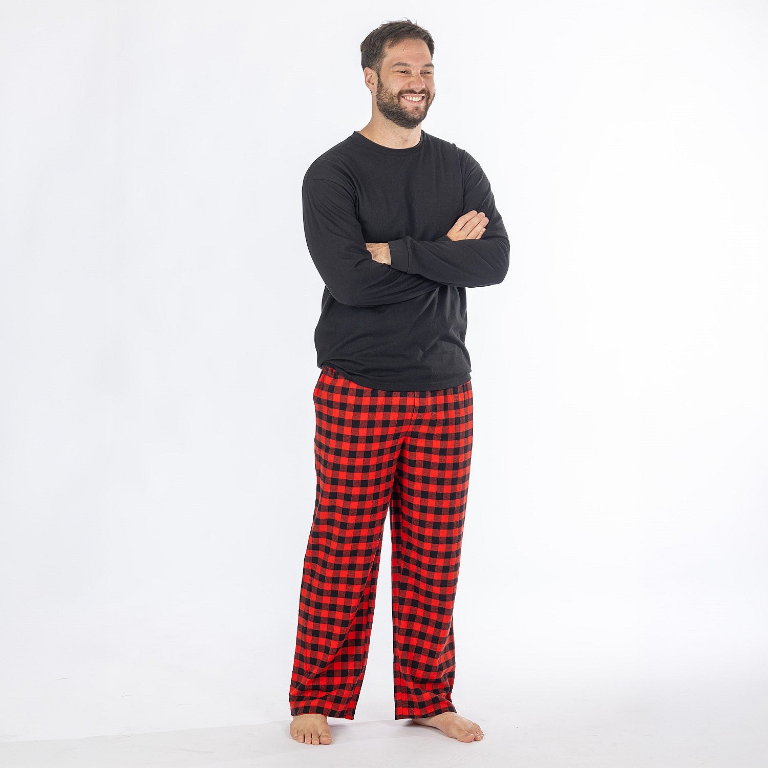 Man wearing a black long sleeve top with red and black check flannelette pyjama pants.