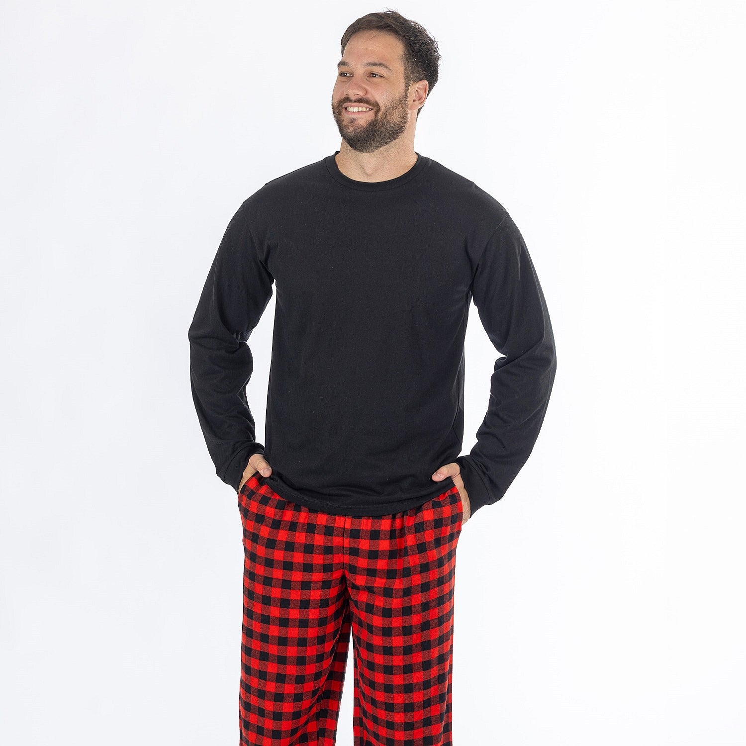 Man wearing a black long sleeve top with red and black check flannelette pyjama pants.