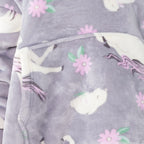 Child wearing a purple unicorn print hooded towel