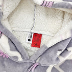 Purple unicorn print hooded towel close-up showing soft sherpa lining.