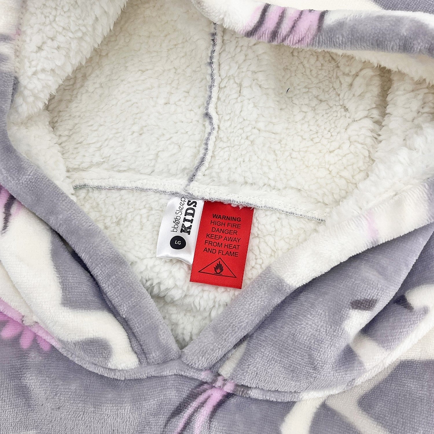 Purple unicorn print hooded towel close-up showing soft sherpa lining.