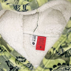 Green dinosaur print hooded towel close-up showing soft sherpa lining.