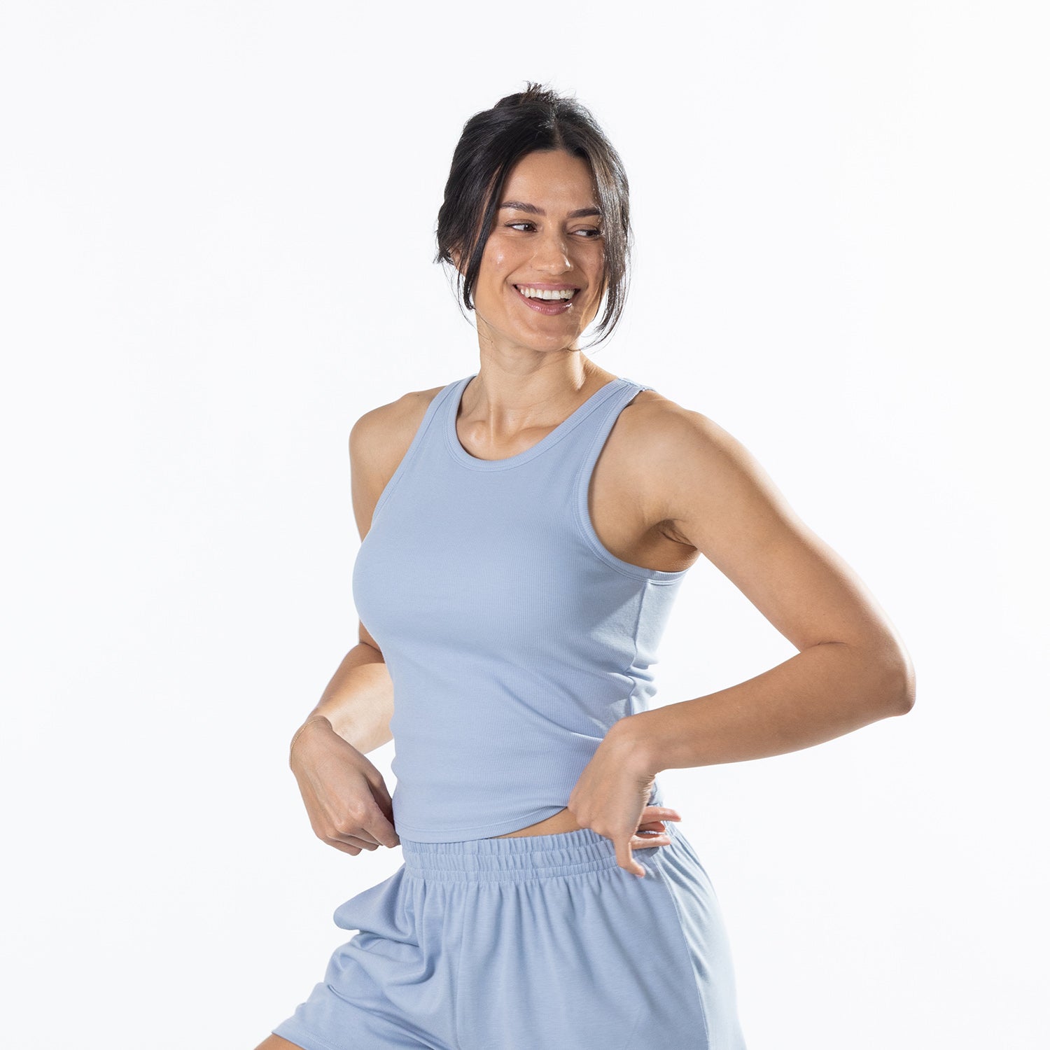 Three-quarter view of the model wearing the Faded Blue Simple & Sunday Lounge Weekend Ribbed Tank Top with matching lounge shorts.
