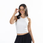 Close-up of the model wearing the White Simple & Sunday Lounge Weekend Ribbed Tank Top with black lounge pants and sunglasses.