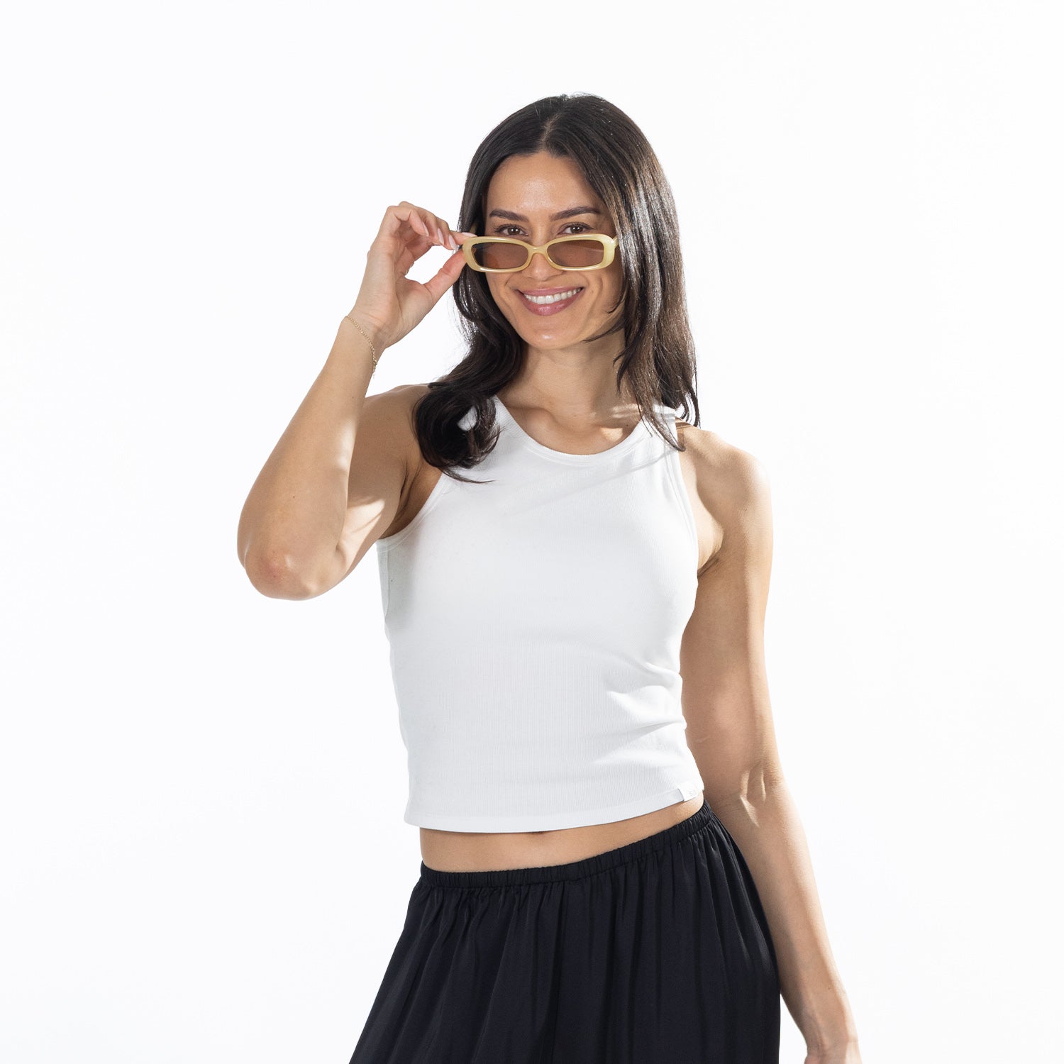 Close-up of the model wearing the White Simple & Sunday Lounge Weekend Ribbed Tank Top with black lounge pants and sunglasses.