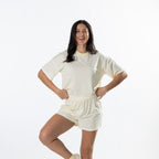 Model wearing yellow striped lounge shorts with a matching striped tee.