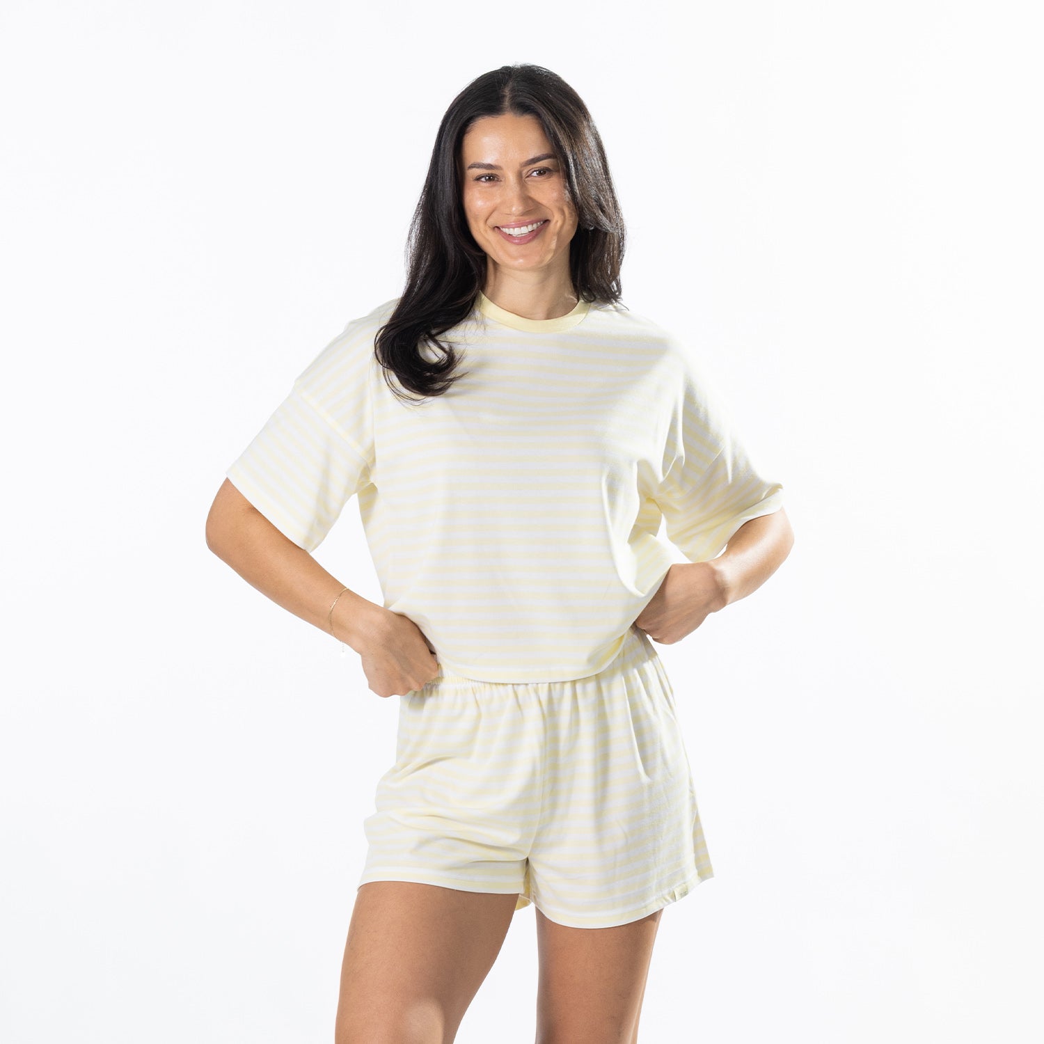 Model wearing yellow striped lounge shorts with a matching striped tee.