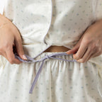 Close-up of the ivory pyjama shorts, showing the elasticated waist with tie detail and matching floral print.