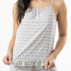 Close-up of the cami pyjama top, showing the thin straps, gathered neckline, geometric print and contrast frill hem.
