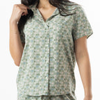 Close-up of the sage floral print button-up pyjama top, showing the collar, short sleeves and chest pocket.