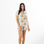 Full-length front view of a woman wearing the multi-coloured fruit print short pyjama set.