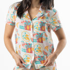 Close-up of the short sleeve button-up pyjama top, showing the collar, chest pocket and colourful summer fruit print.