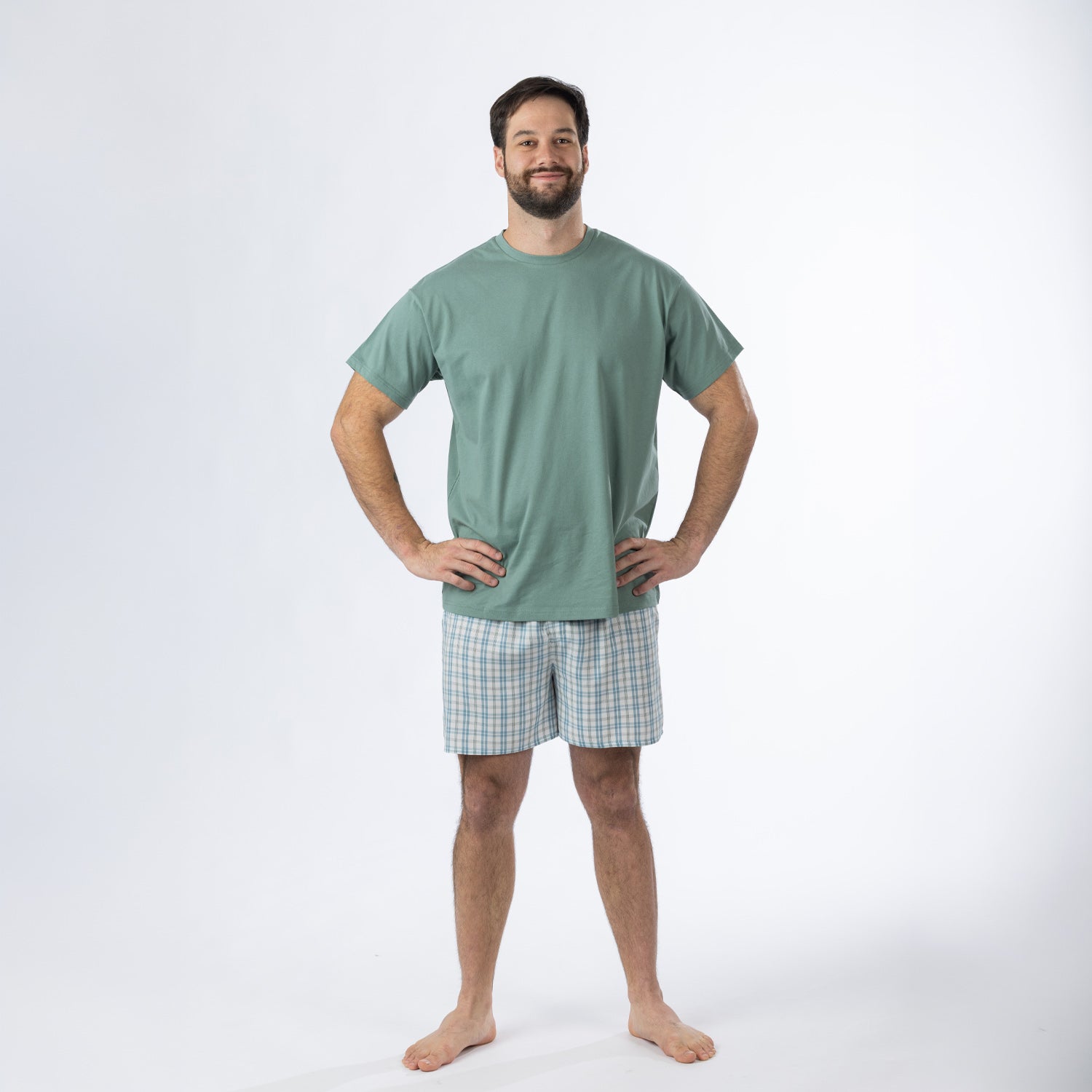 Design Plus Men’s Check PJ Set Blue, featuring a sage green short-sleeve T-shirt with blue and white check shorts, shown full length on a model.