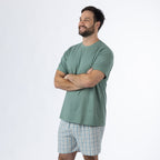 Design Plus Men’s Check PJ Set Blue, shown on a model with arms crossed, highlighting the relaxed T-shirt and coordinating check shorts.