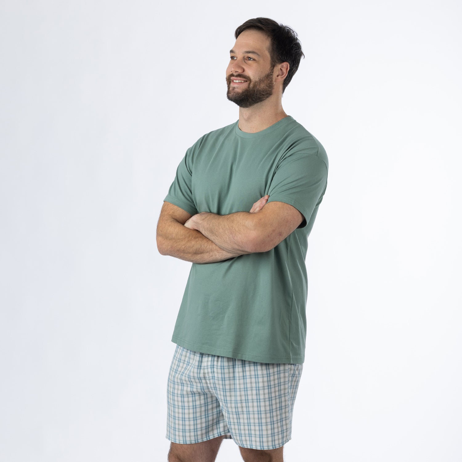 Design Plus Men’s Check PJ Set Blue, shown on a model with arms crossed, highlighting the relaxed T-shirt and coordinating check shorts.