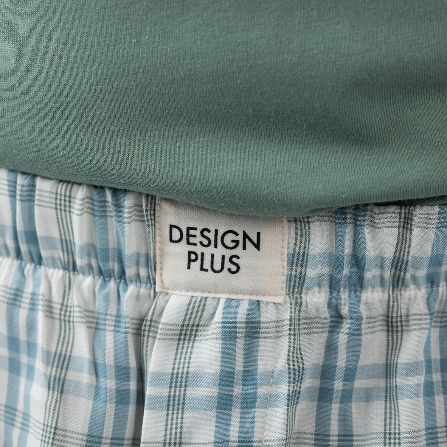 Close-up of the Design Plus Men’s Check PJ Set Blue, showing the Design Plus label and blue check pattern on the shorts.