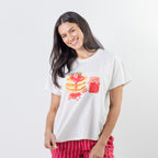 A relaxed-fit white sleep tee features a playful pancake and strawberry jam graphic, adding a fun, feel-good touch to cosy nights and lazy mornings.