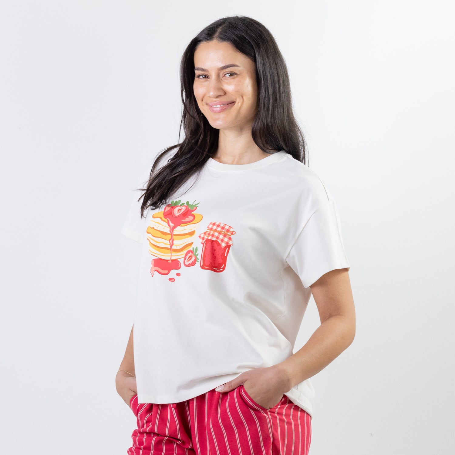 A relaxed-fit white sleep tee features a playful pancake and strawberry jam graphic, adding a fun, feel-good touch to cosy nights and lazy mornings.