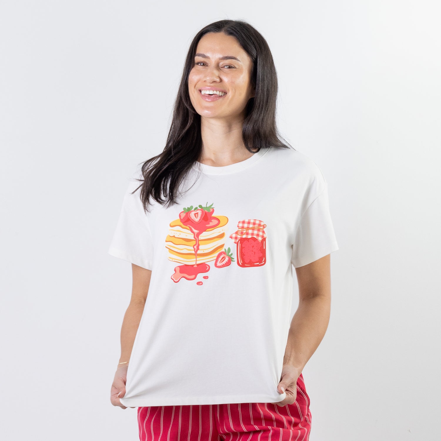 A relaxed-fit white sleep tee features a playful pancake and strawberry jam graphic, adding a fun, feel-good touch to cosy nights and lazy mornings.