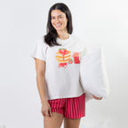 A relaxed-fit white sleep tee features a playful pancake and strawberry jam graphic, adding a fun, feel-good touch to cosy nights and lazy mornings.