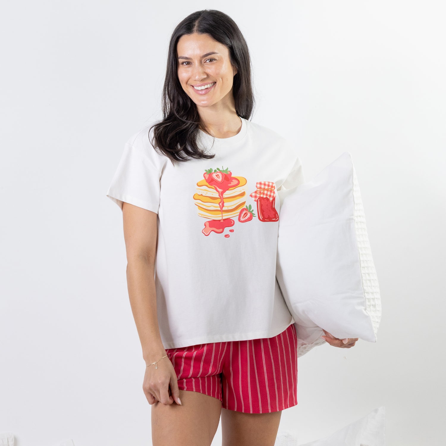 A relaxed-fit white sleep tee features a playful pancake and strawberry jam graphic, adding a fun, feel-good touch to cosy nights and lazy mornings.