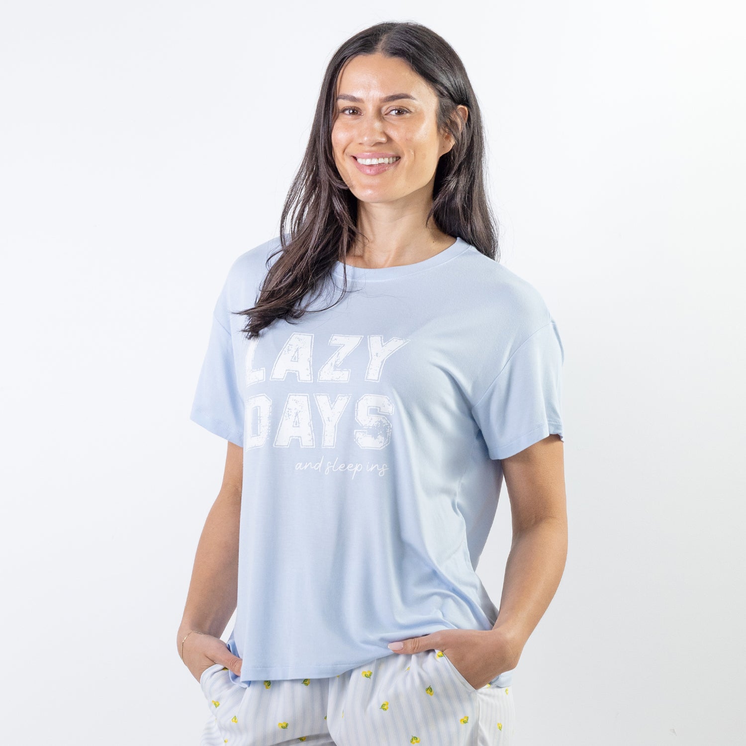 A soft blue sleep tee featuring a "Lazy Days and Sleeping In" graphic offers a relaxed, laid-back style that's perfect for cosy nights and slow mornings.