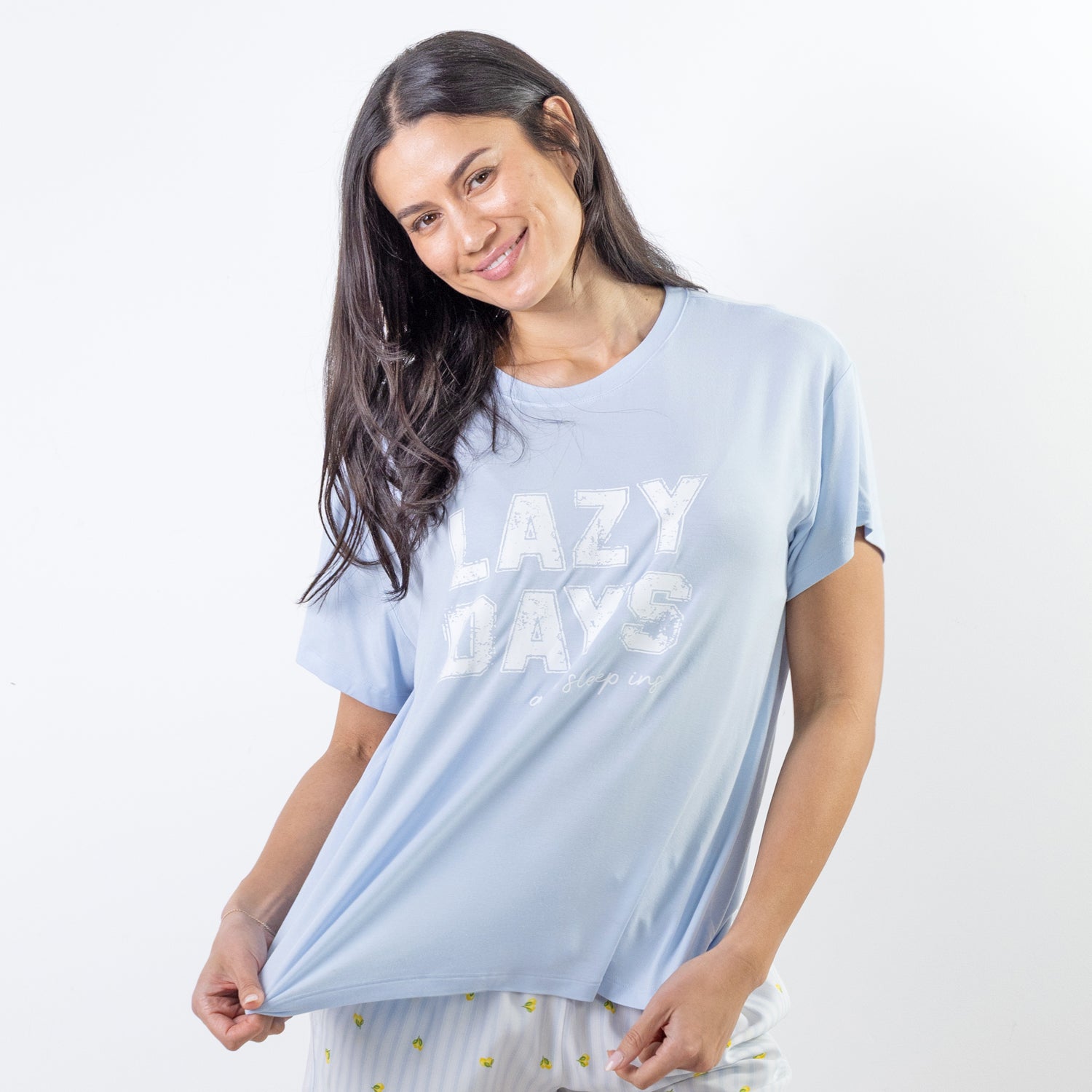 A soft blue sleep tee featuring a "Lazy Days and Sleeping In" graphic offers a relaxed, laid-back style that's perfect for cosy nights and slow mornings.