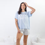 A soft blue sleep tee featuring a "Lazy Days and Sleeping In" graphic offers a relaxed, laid-back style that's perfect for cosy nights and slow mornings.