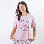 A soft pink sleep tee features a playful heart graphic with the words "L'Amour Est Déclaré," creating a sweet, feminine look that's perfect for cosy nights and relaxed mornings.